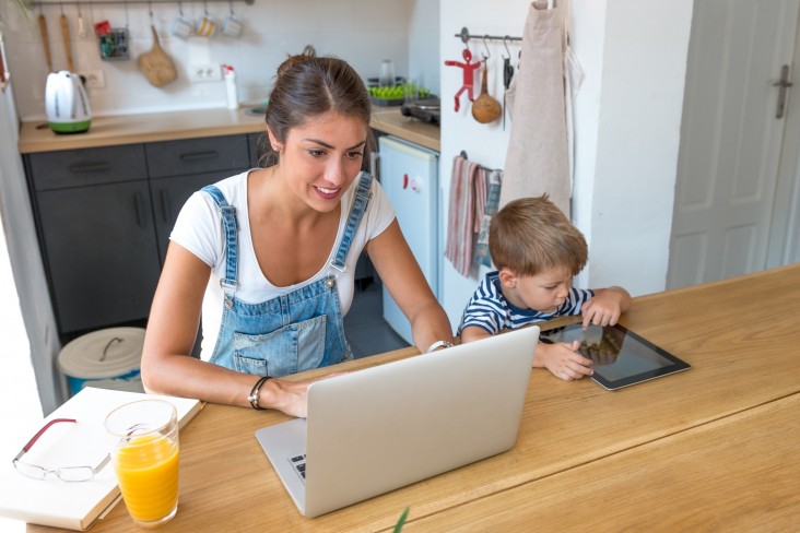 Woman on laptop with child
