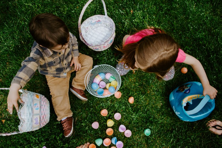 Photo of two children outside with Easter eggs