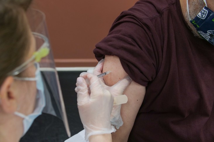 Nurse giving person vaccine 