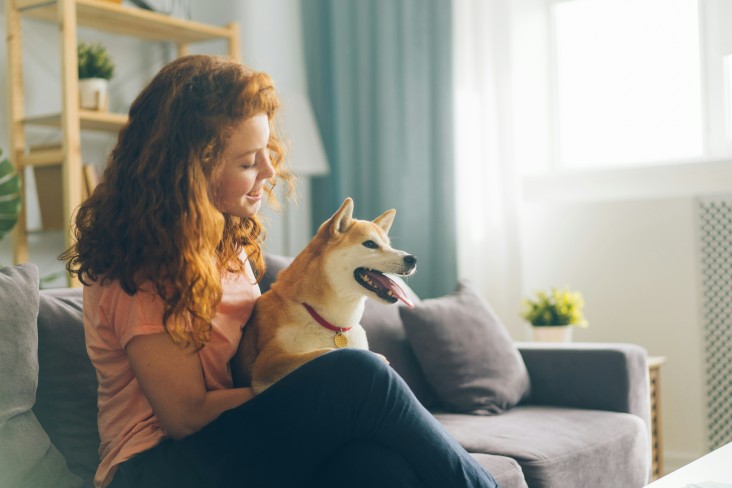 Woman on couch with dog